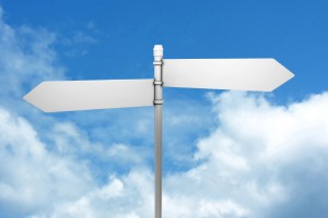 Signpost in blue sky with clouds